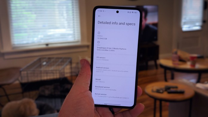 Людина, яка тримає смартфон Poco F7 Pro, що відображає детальну інформацію та технічні характеристики, зі світлим приміщенням на задньому плані.